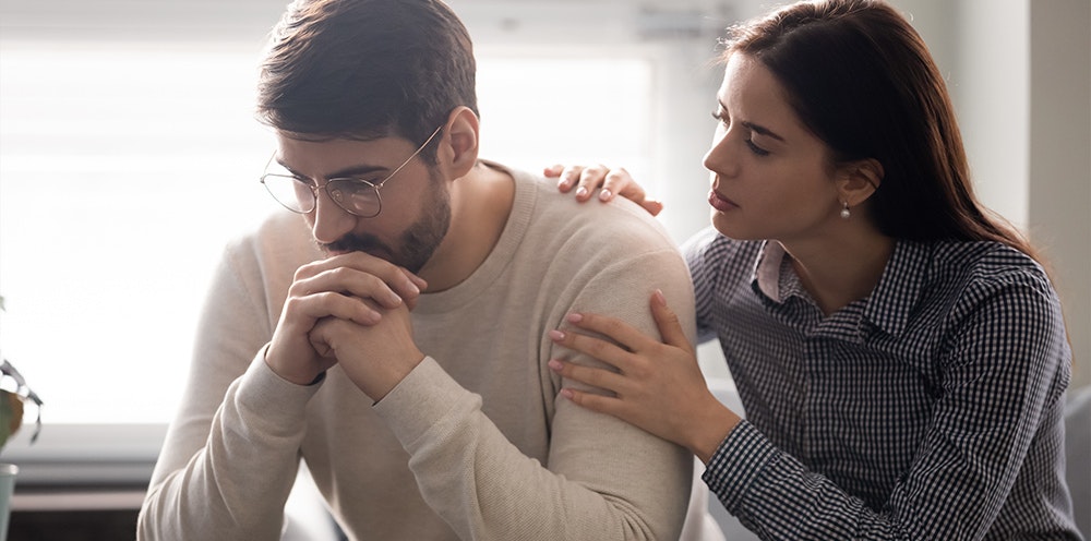 a woman comforting a man