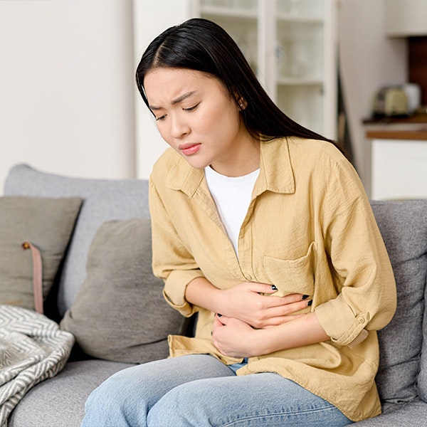 Woman with diminished ovarian reserve holding stomach