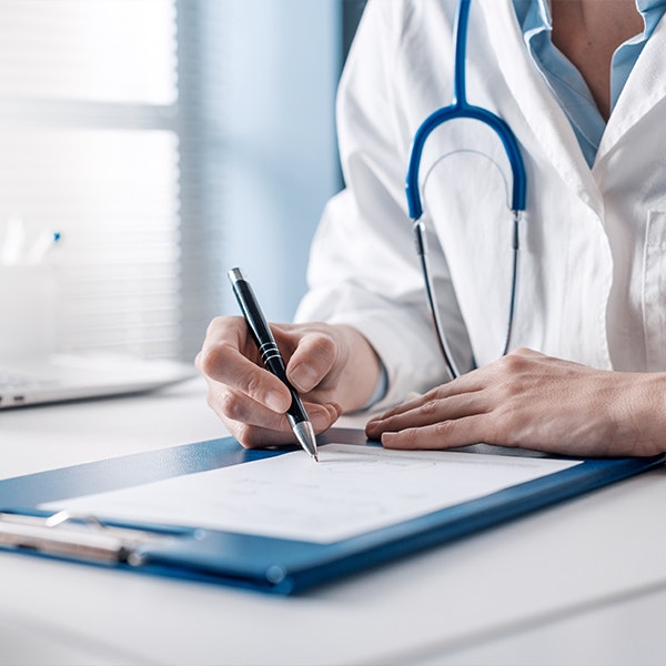 a doctor filling out paperwork