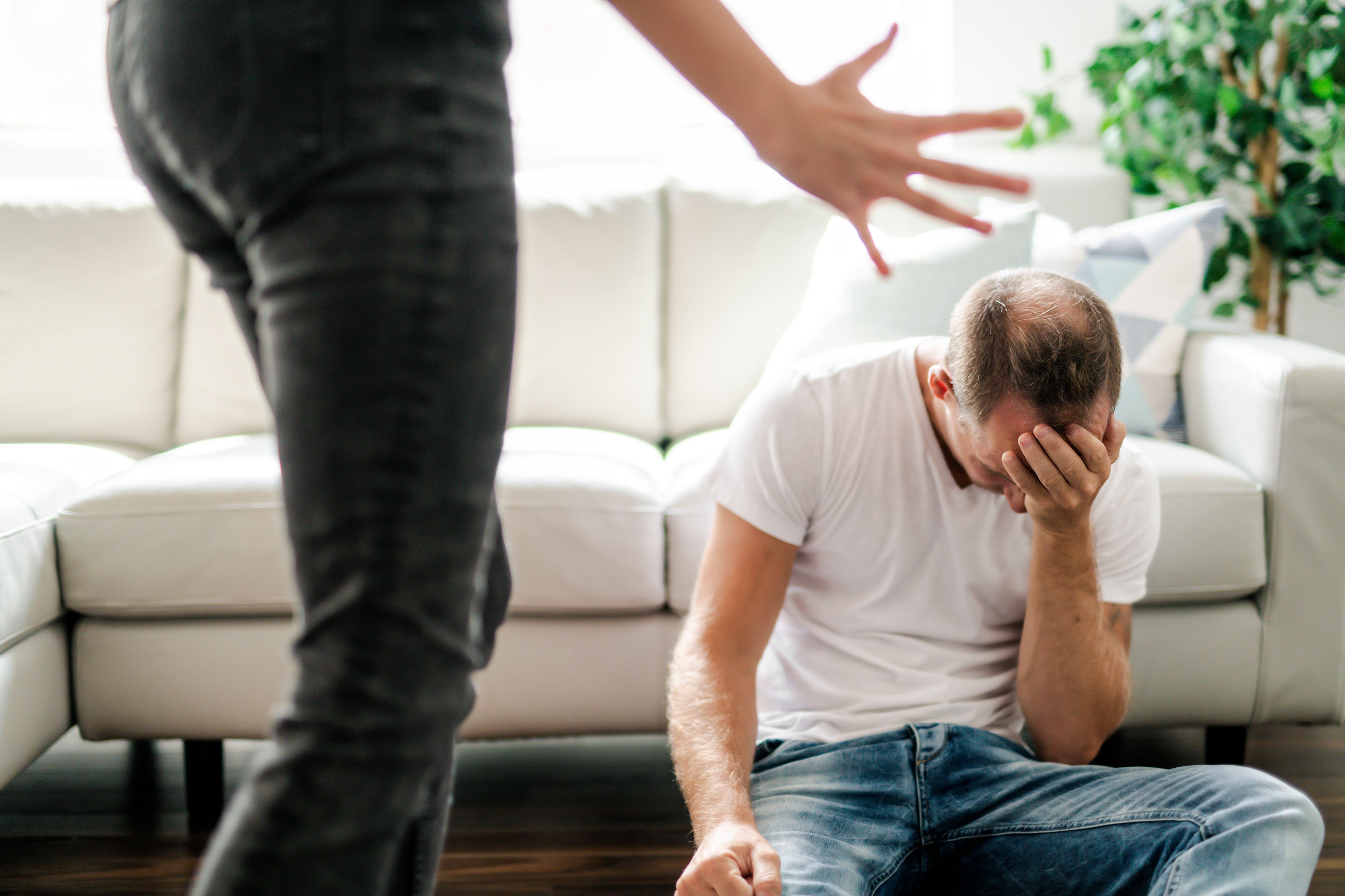 Woman yelling at hurt man on floor