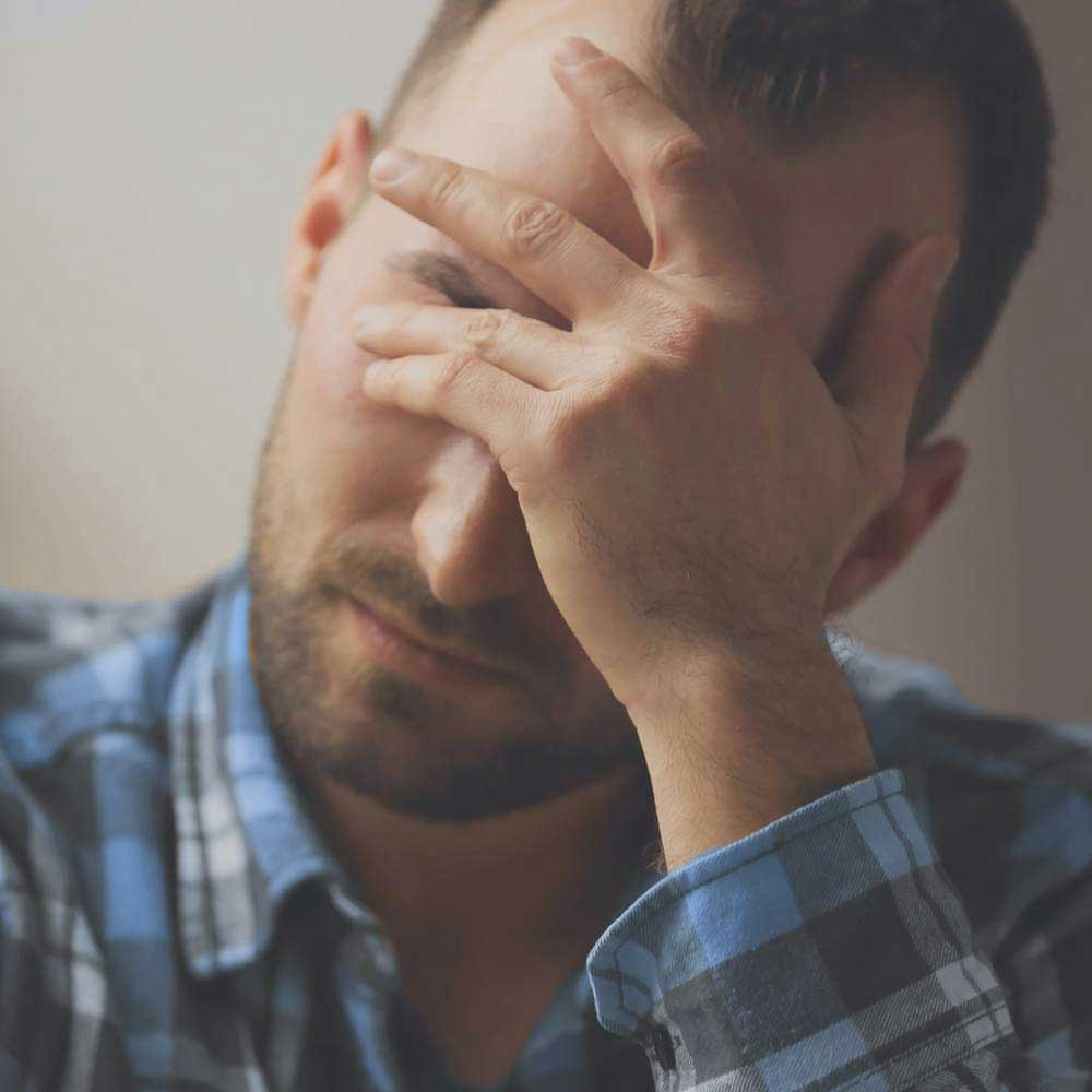 Man holding head in hands
