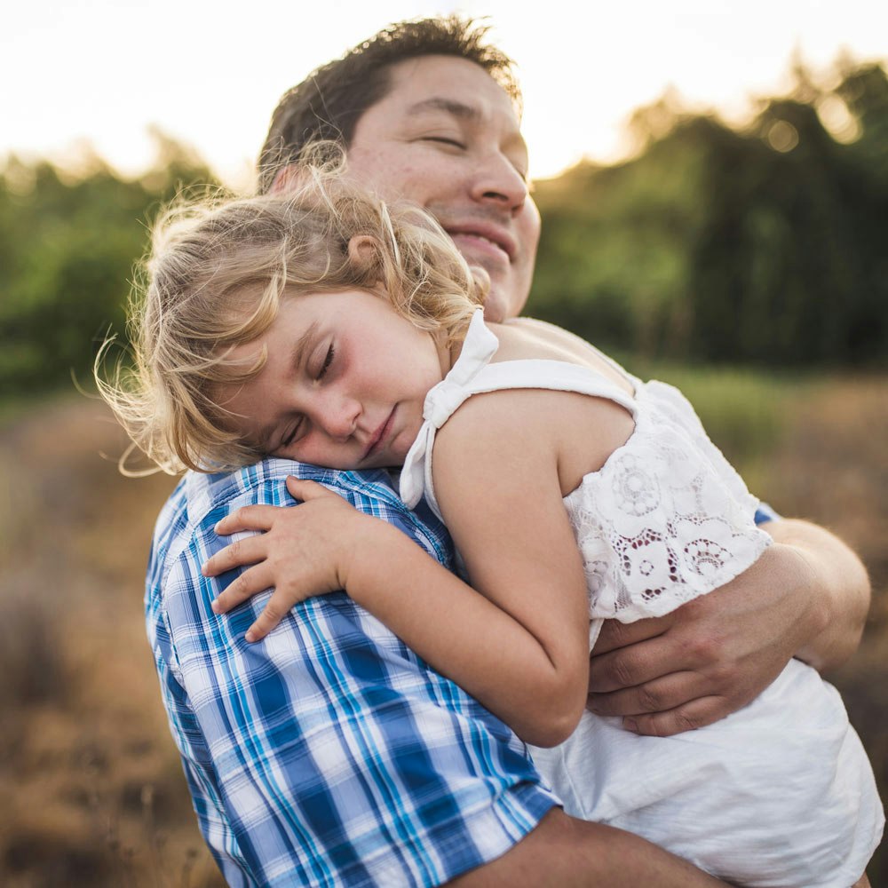 Happy father and baby daughter hugging each other