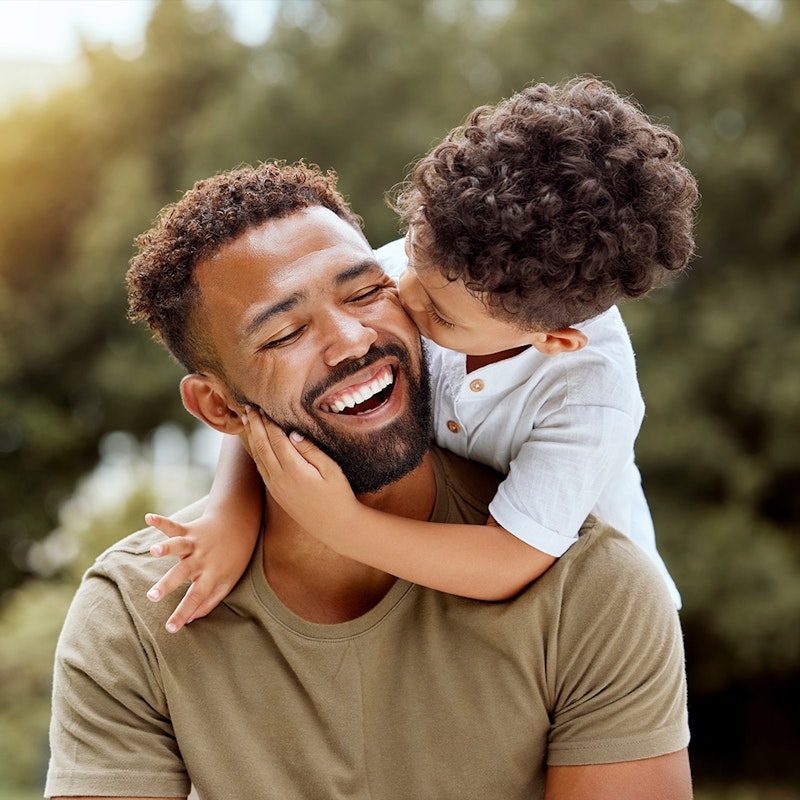 Son hugging and kissing father