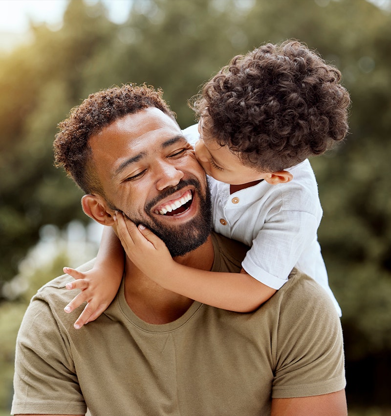 Son hugging and kissing father