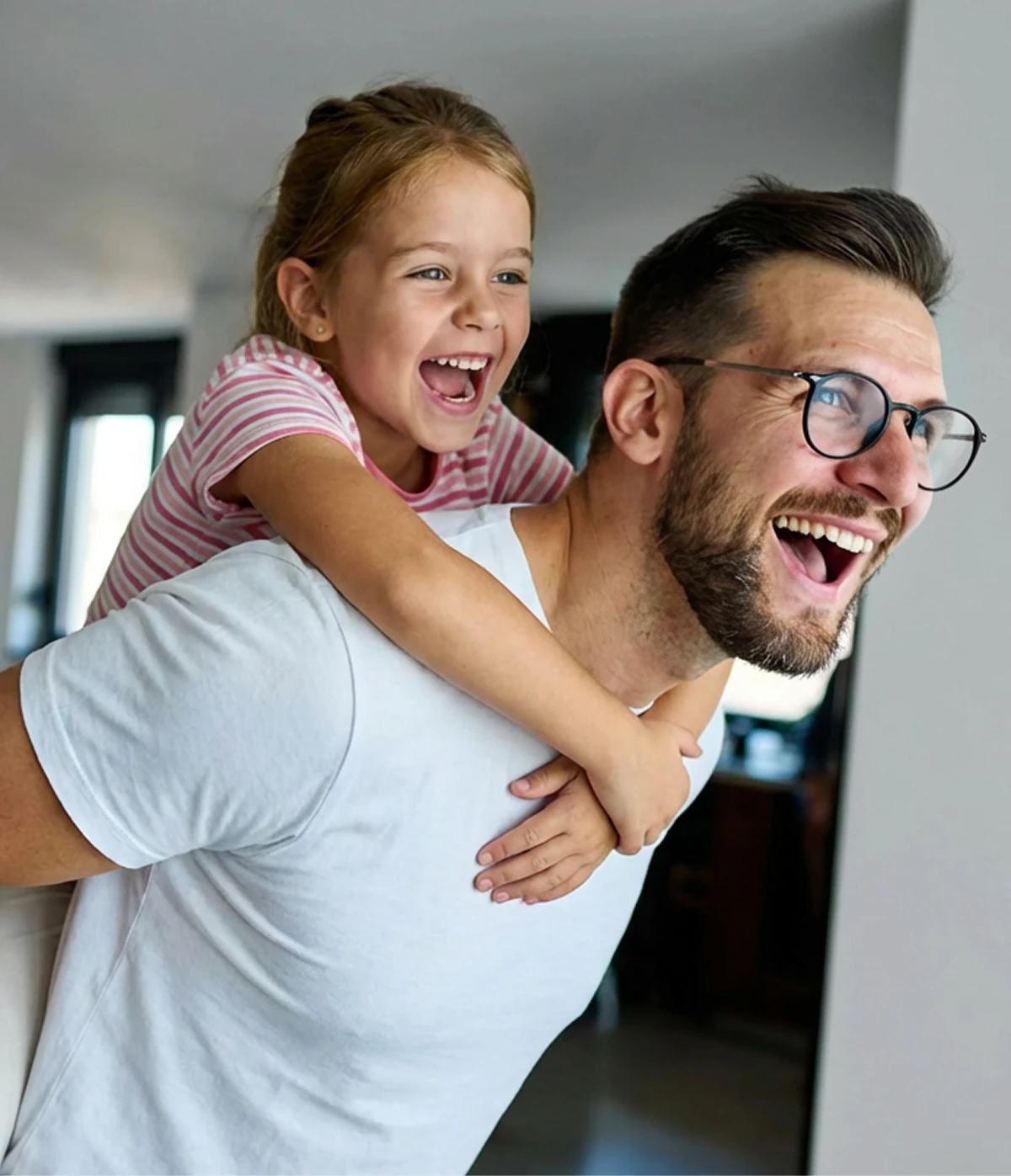 Happy dad piggybacking little girl