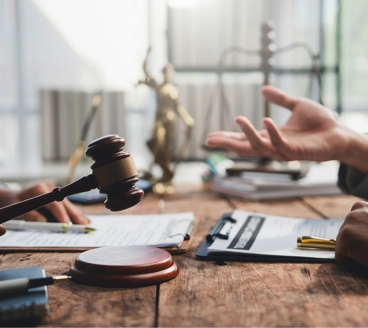 hand reaching toward gavel