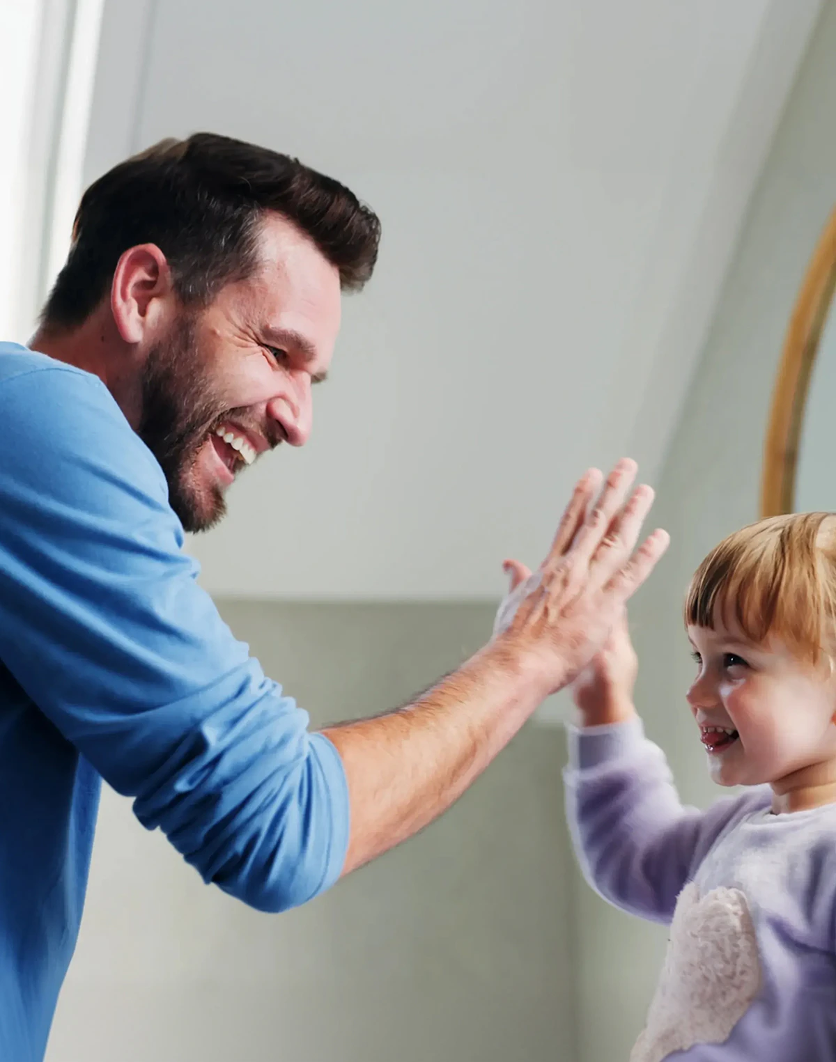Father giving his young girl a high five