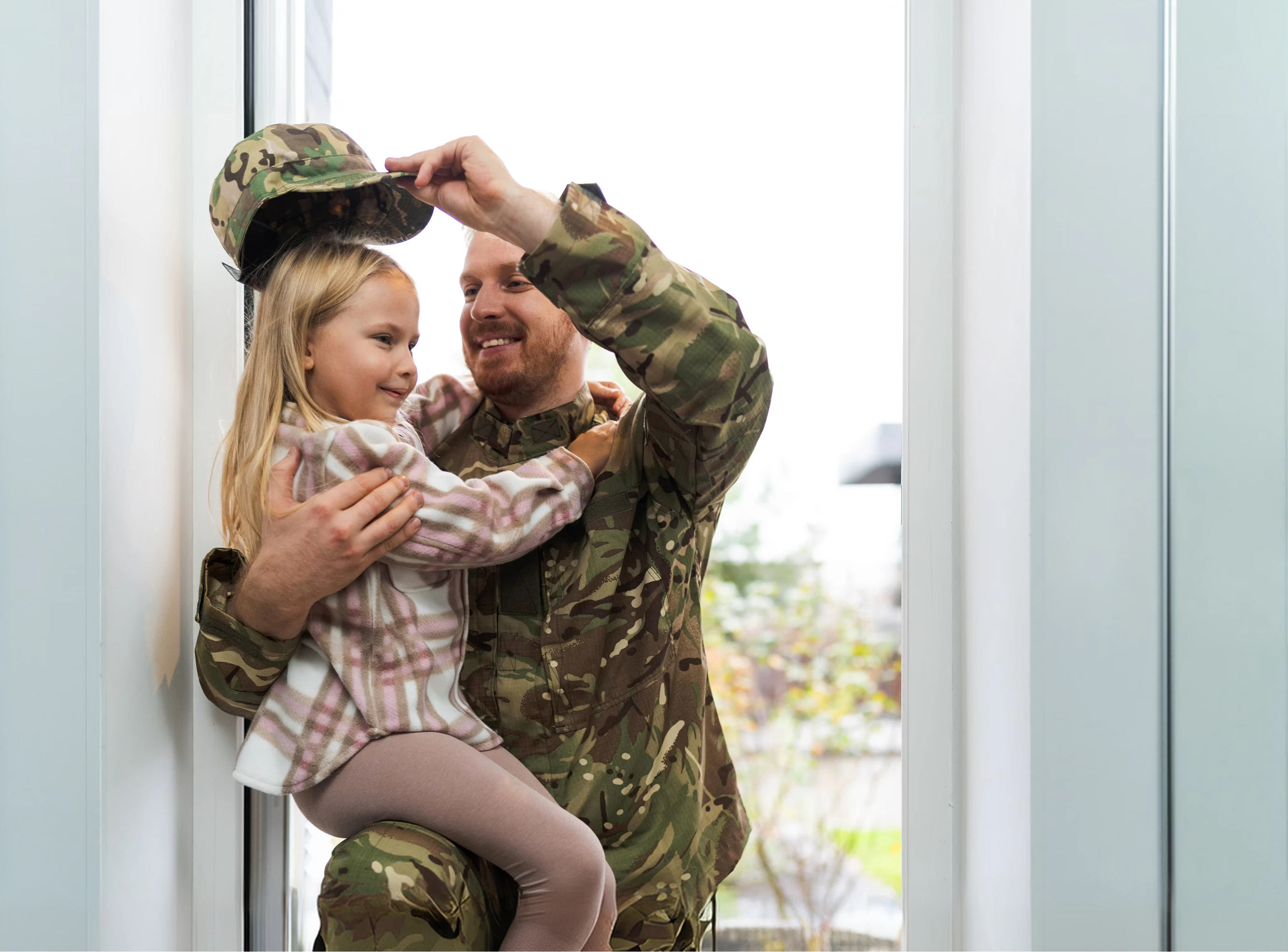 service member holding child
