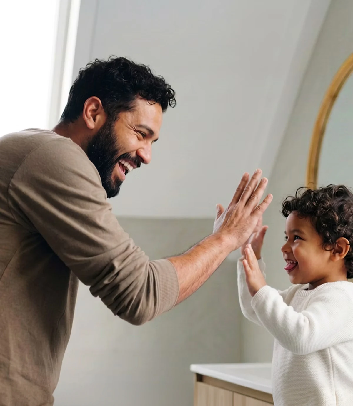 man giving child high five