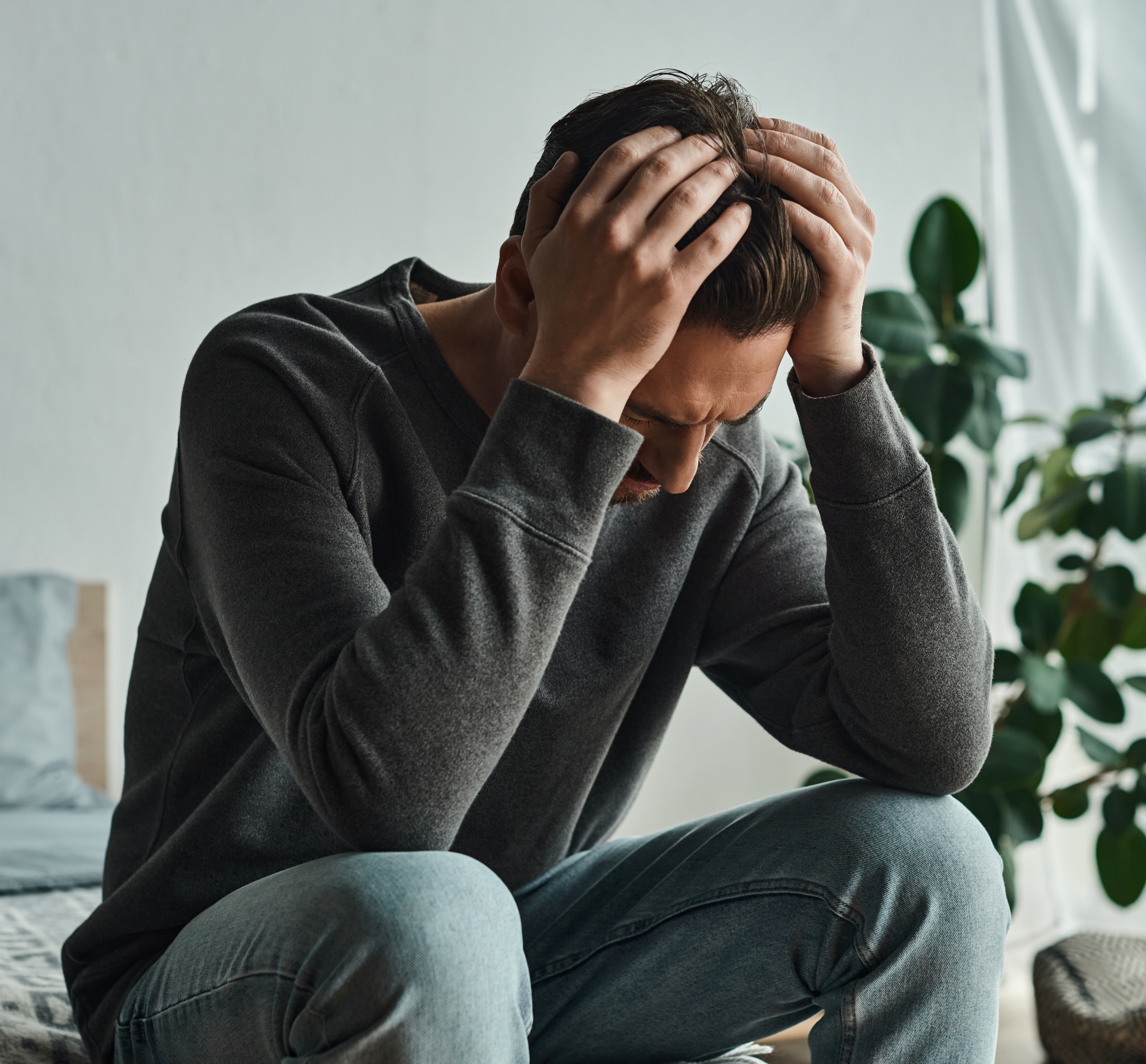 Man holding head in confused state