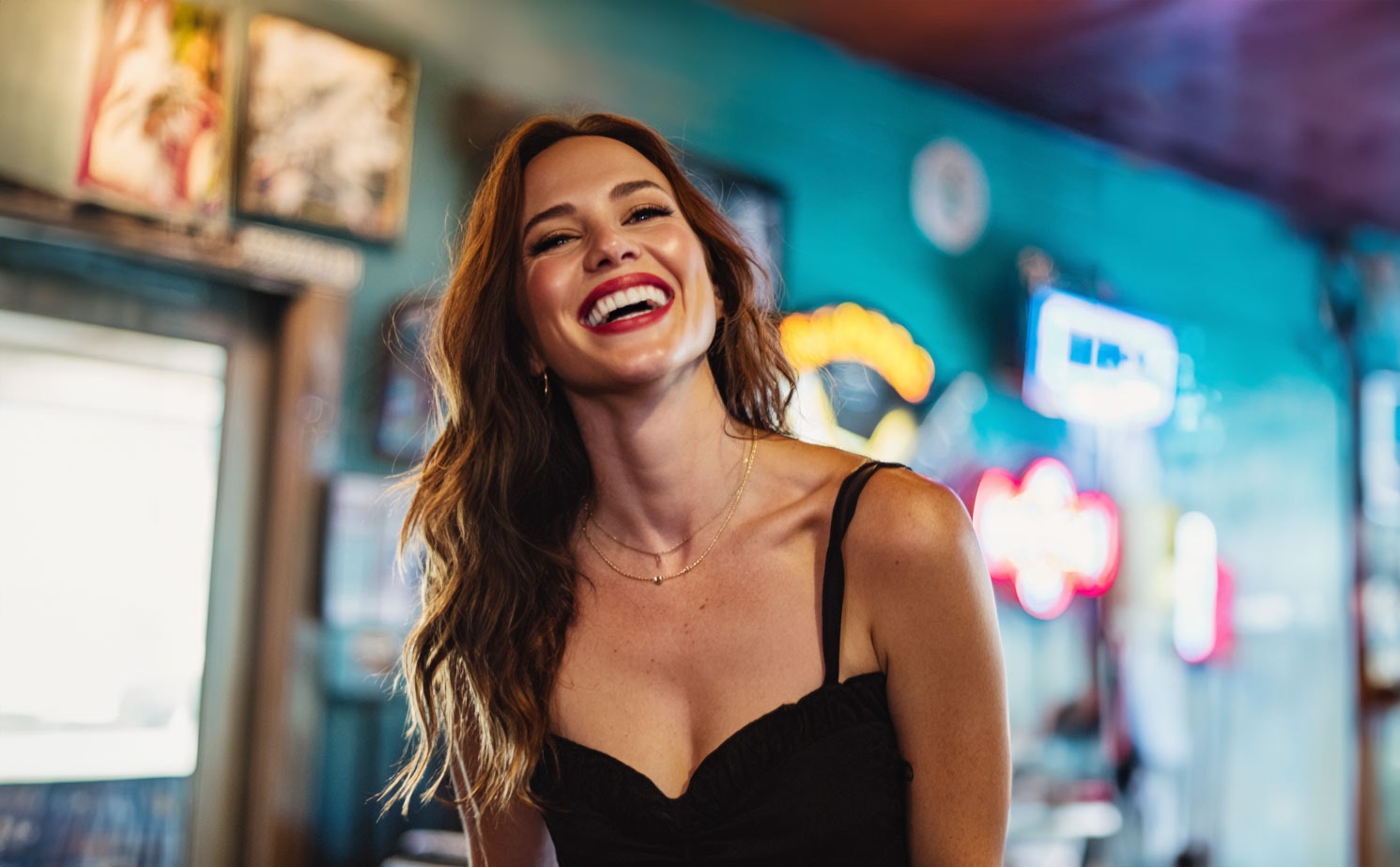 Woman smiling wide near neon signs