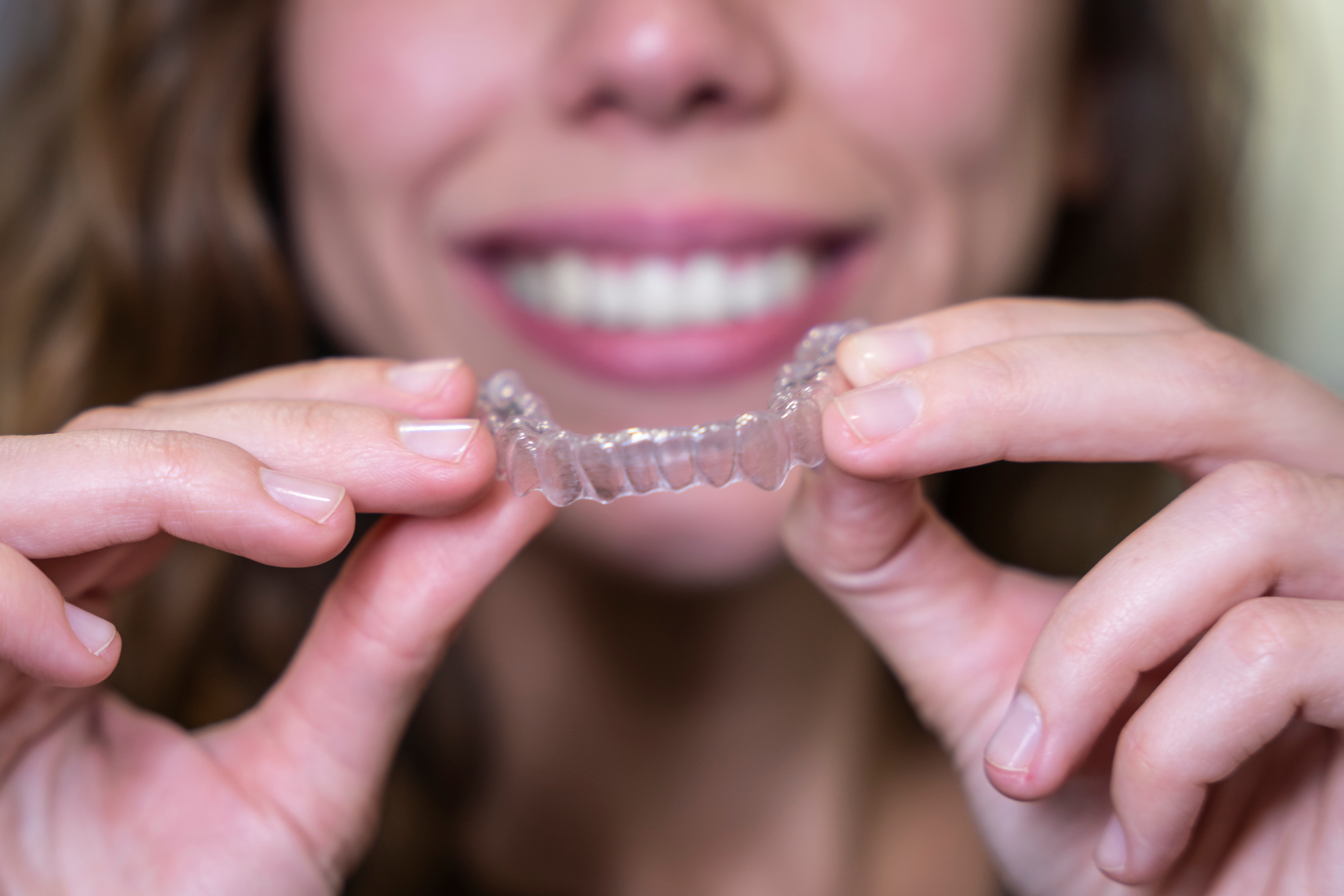 close-up of woman holding Invisalign