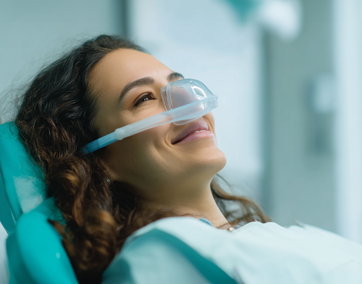 woman smiling while wearing a nitrous oxide mask
