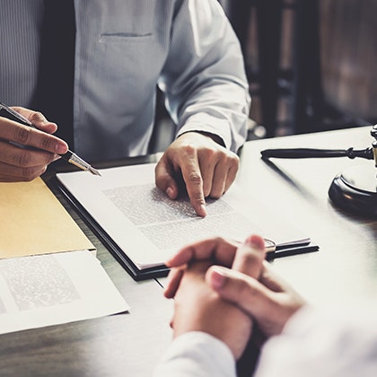 Hands of two men over a desk