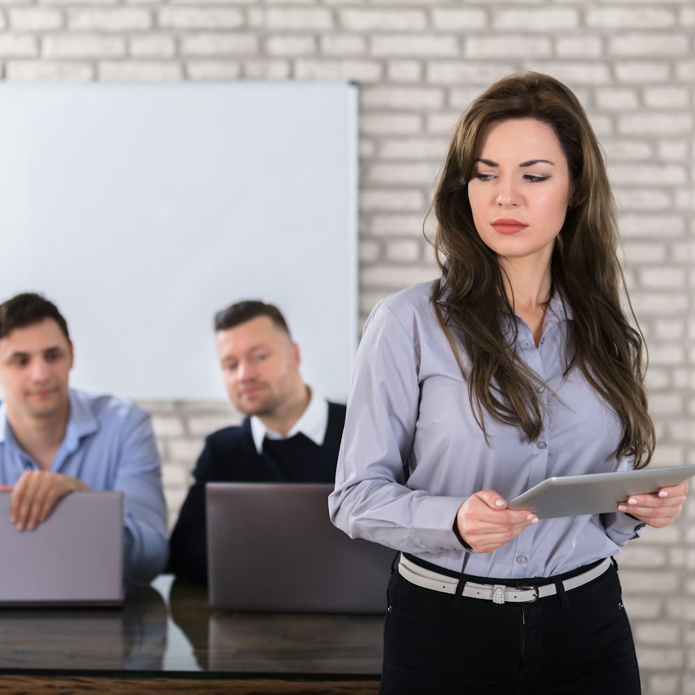 Woman being sexual harassed by coworkers