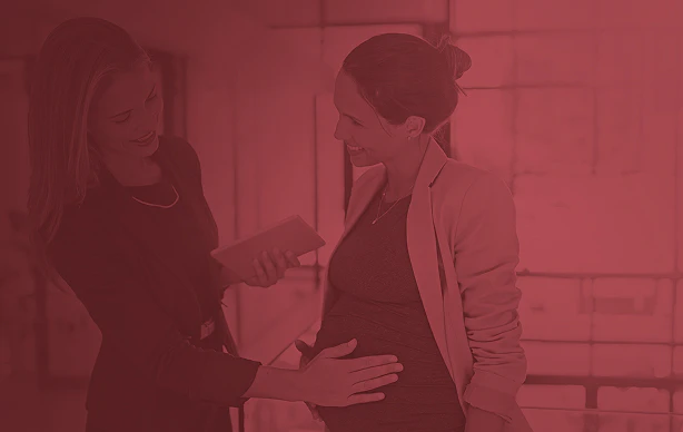A woman touching a pregnant woman