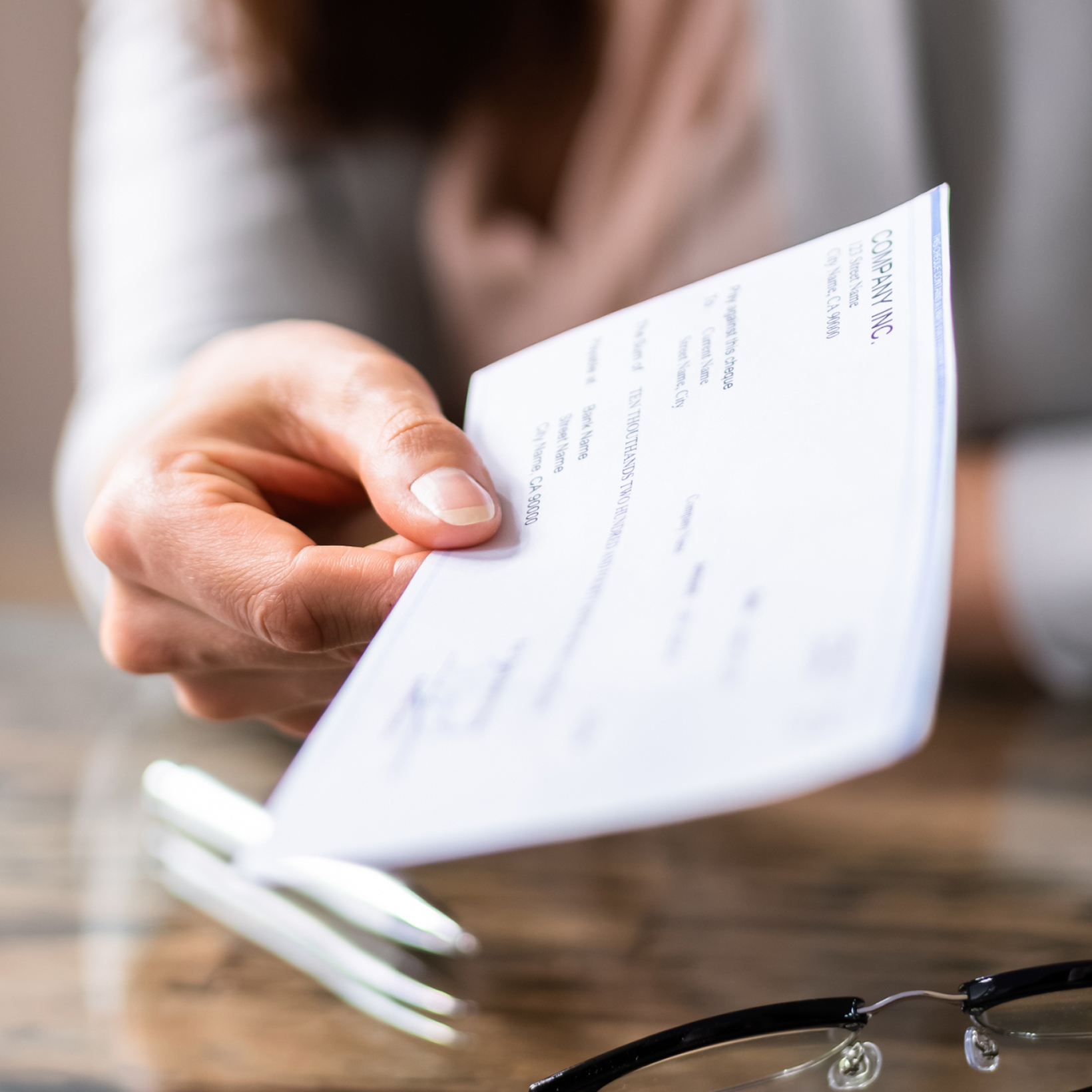 person handing over check