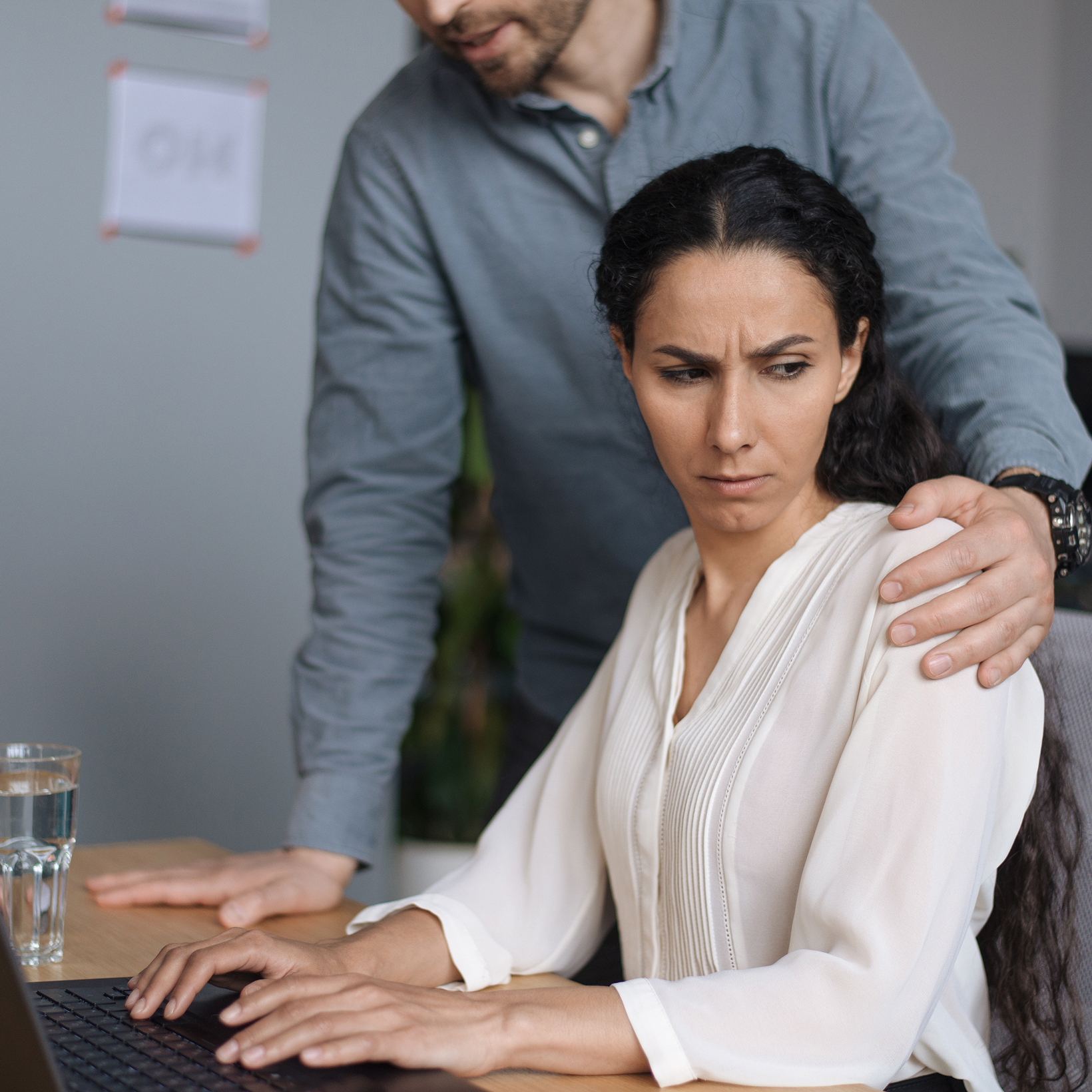 man holding a woman's shoulder
