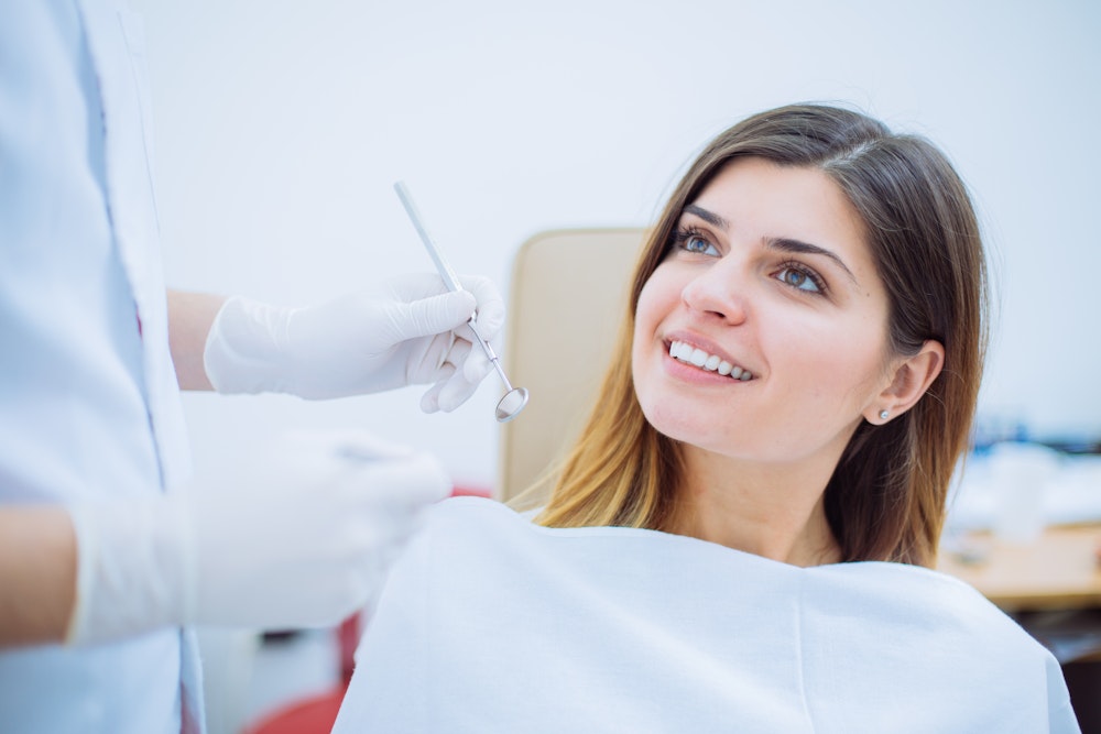 woman smiling in dental chair during crown appointment
