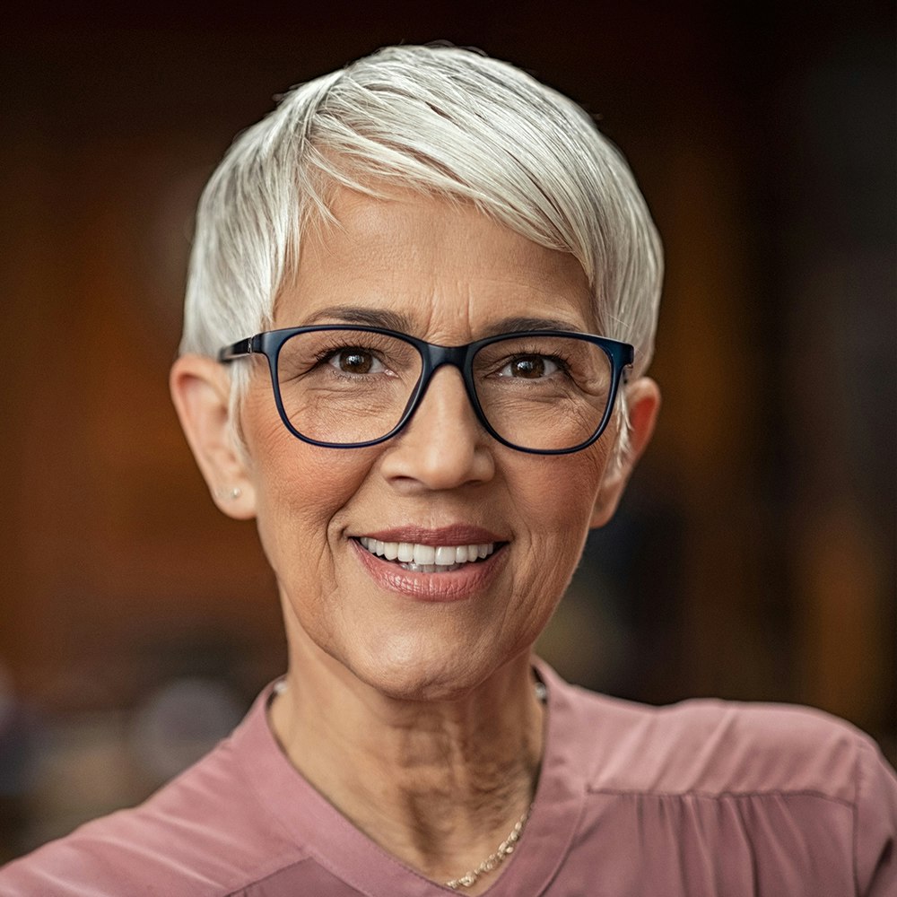 an older woman smiling after full mouth reconstruction