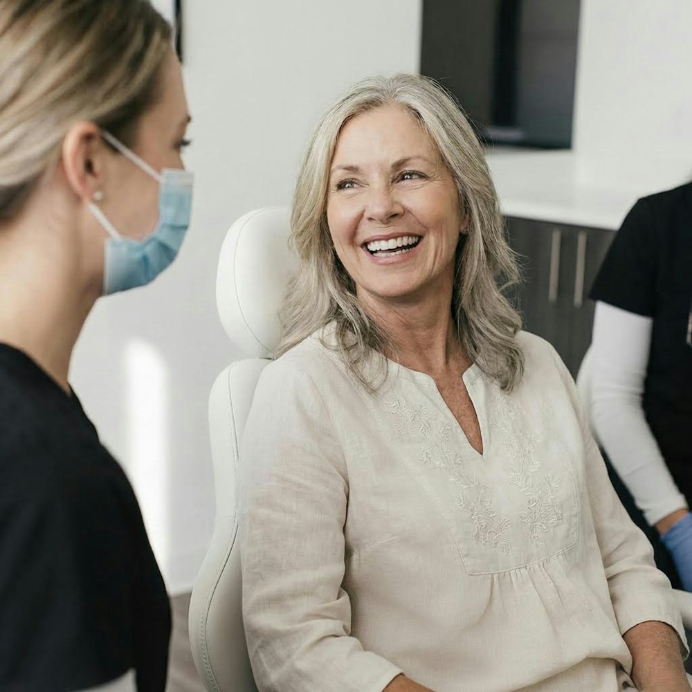 an older woman smiling after full mouth reconstruction