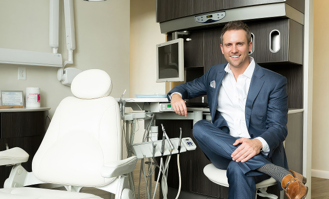 Dr. Newman sitting in a dental exam room