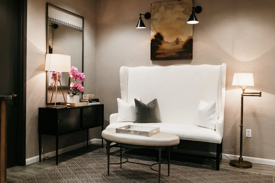 Lounge with a white settee, soft lamps and fresh flowers