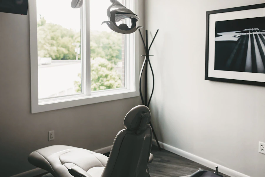 Bright treatment room with a window and black and white artwork