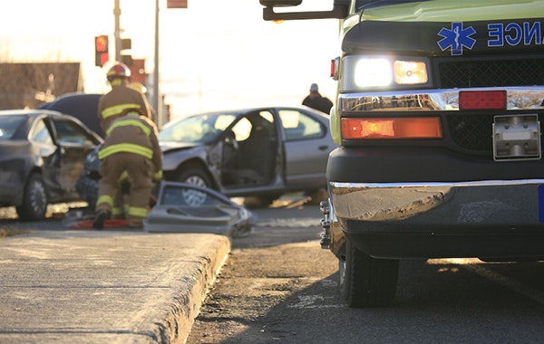 Ambulance truck in front of car wreck