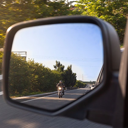 Motorcyclist in side-view mirror