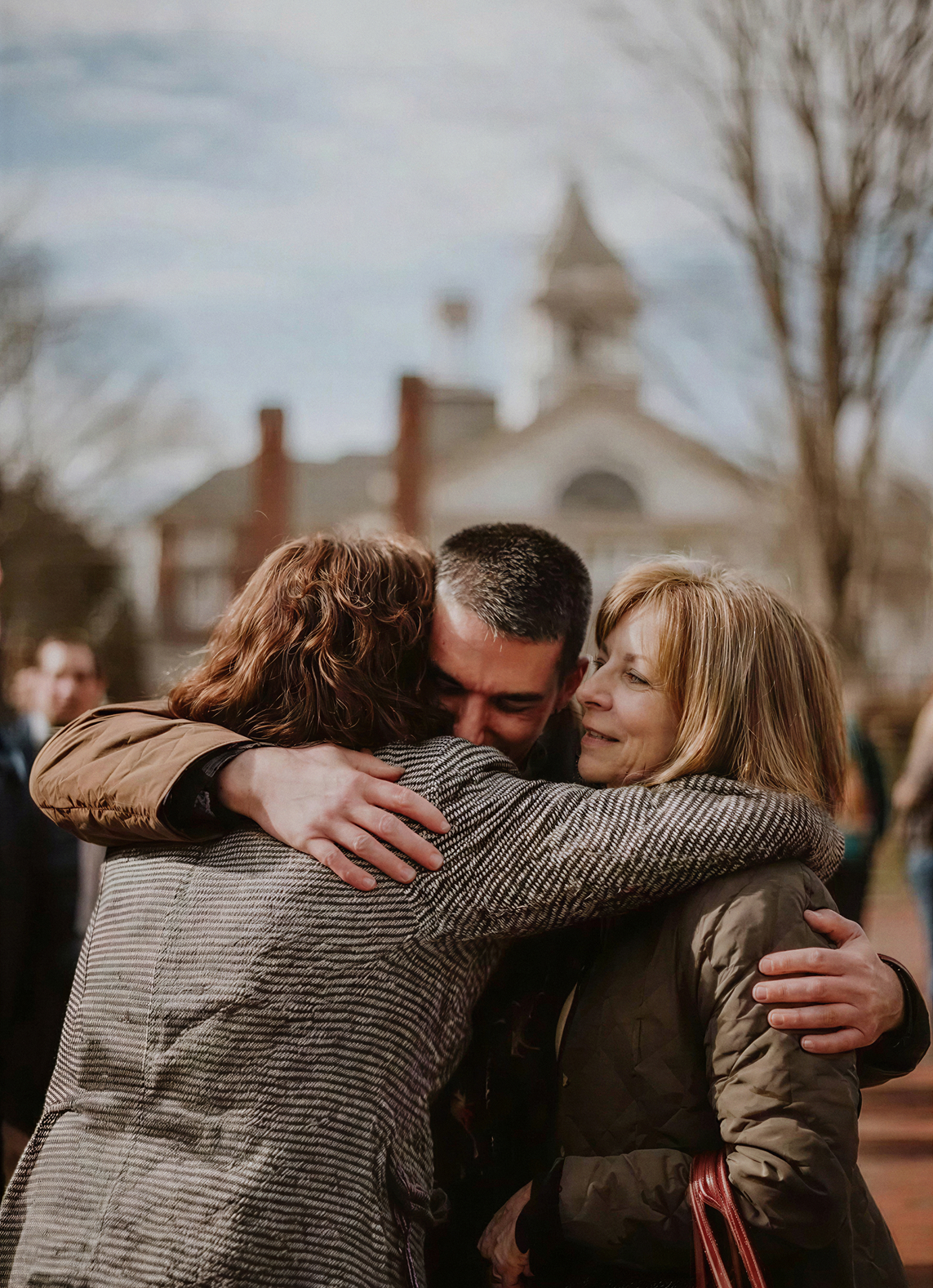 Relieved man hugging family