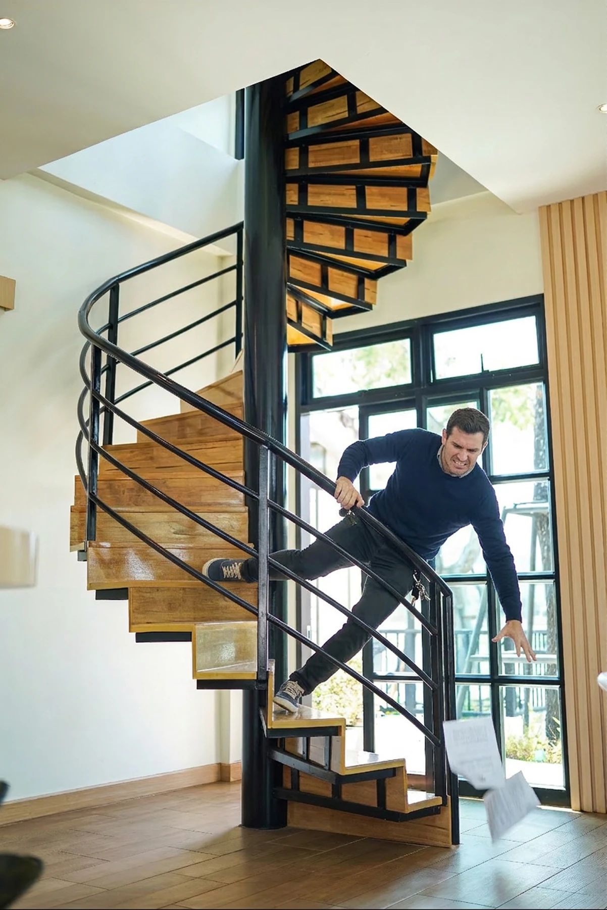Man falling down spiral staircase