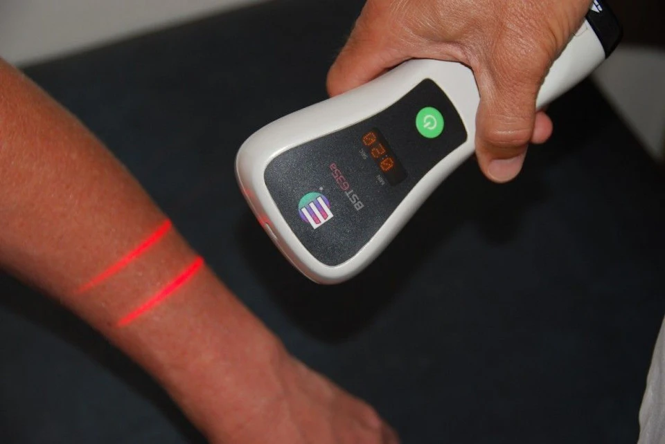 Photo of a patient receiving cold laser therapy