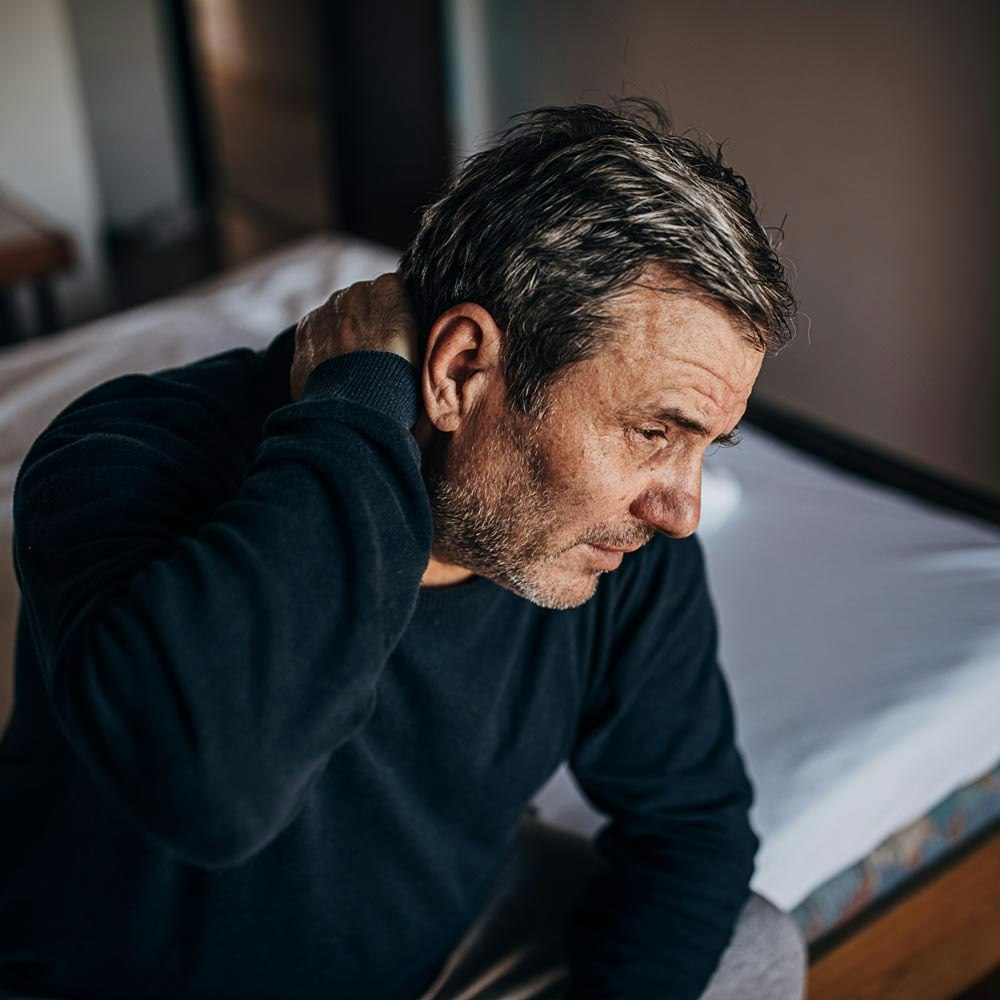 Man holding neck in pain