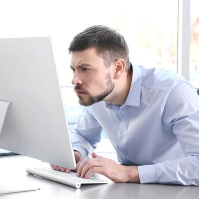Man staring intensely at computer screen