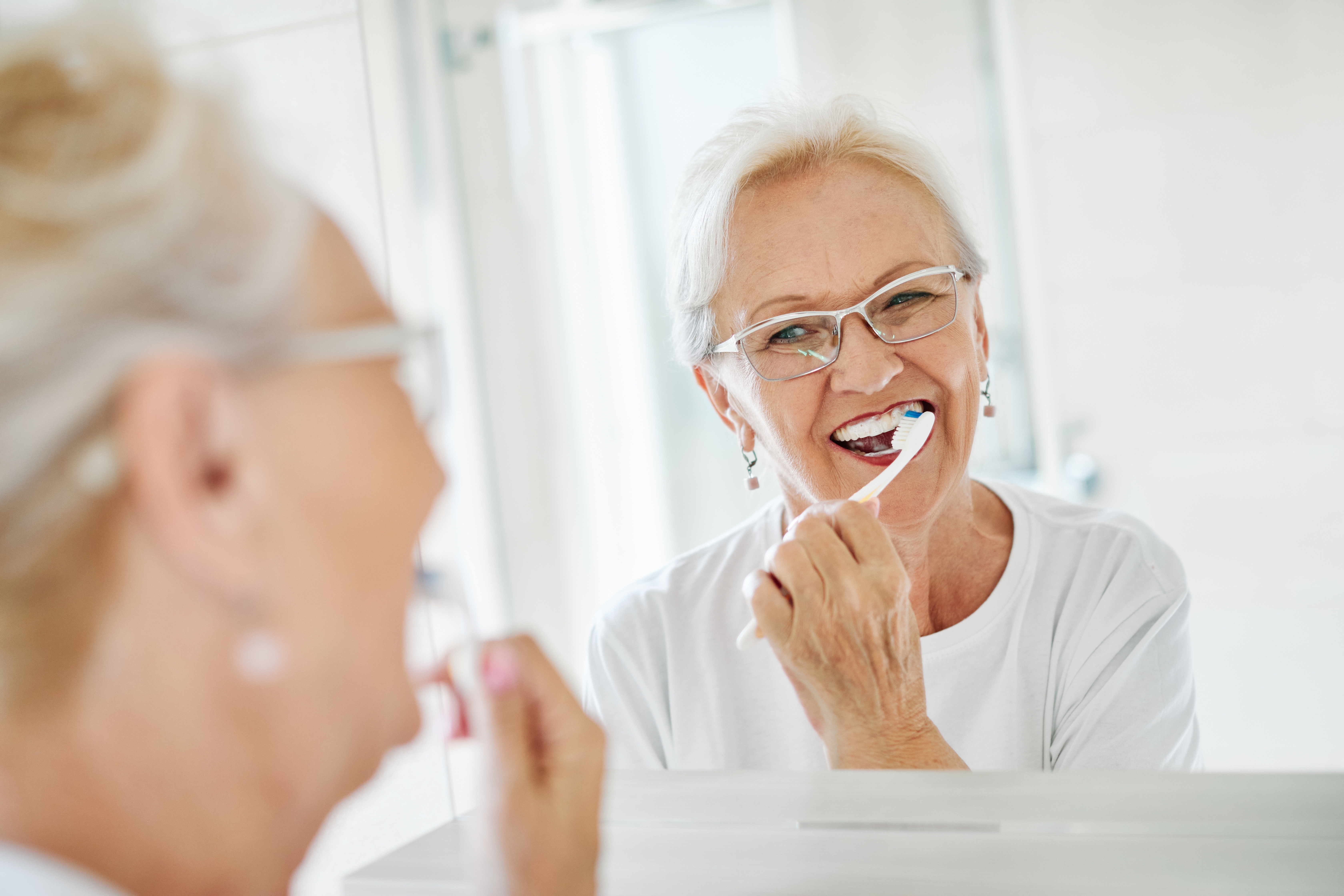 Senior woman brushing her teeth
