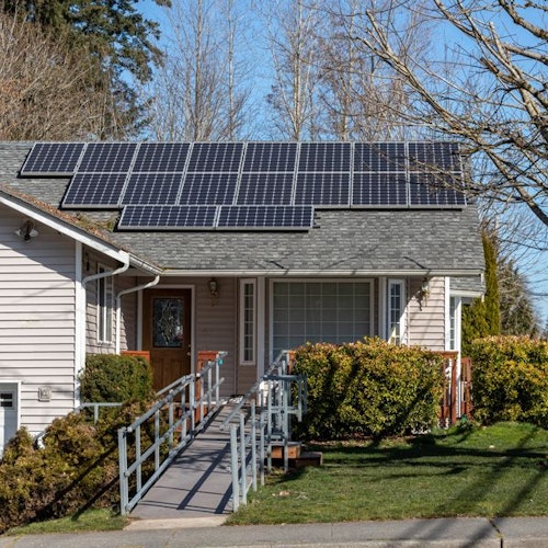 House with accessibility ramp leading to front door