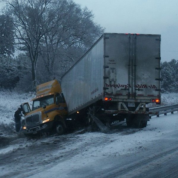 Jackknifed truck off the road in the snow
