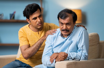 man comforting his father