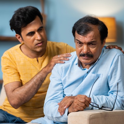 man comforting his father