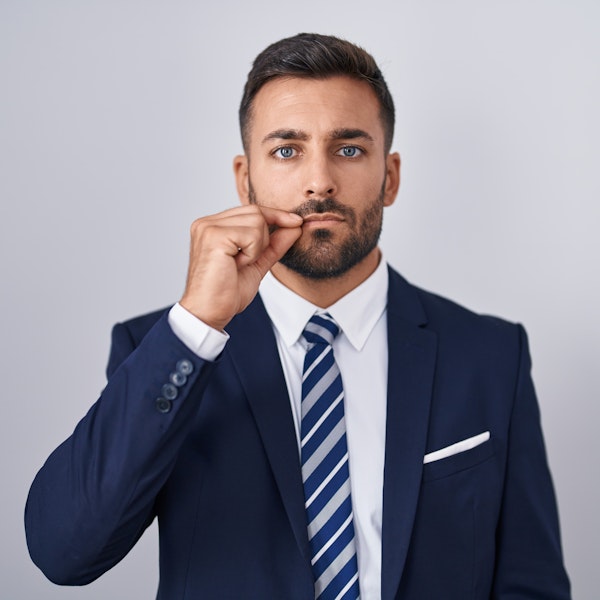 Man giving "lips sealed" gesture