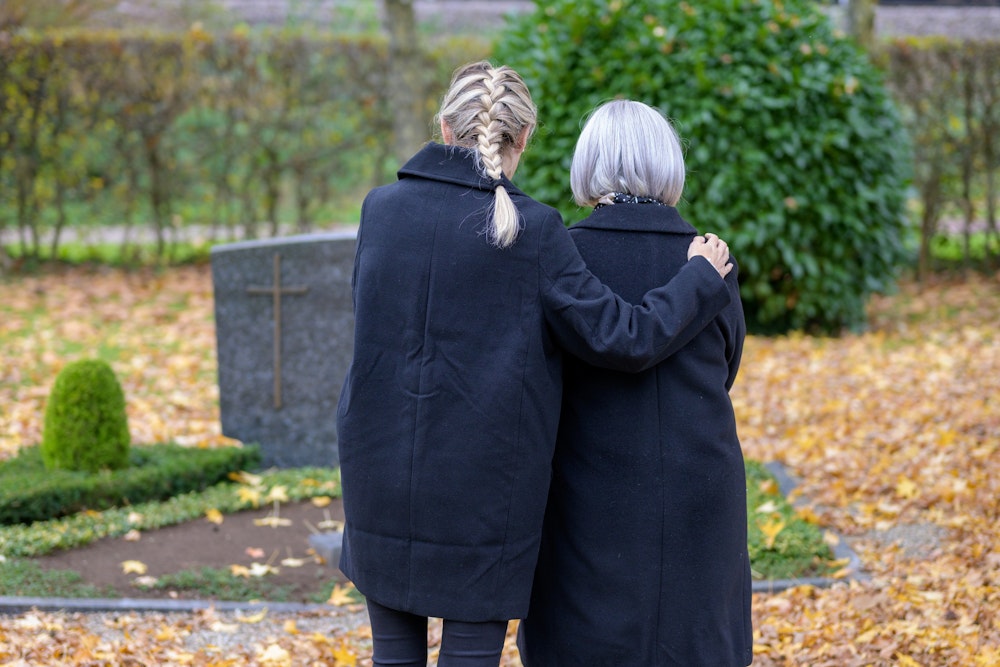 Grieving women at a gravesite