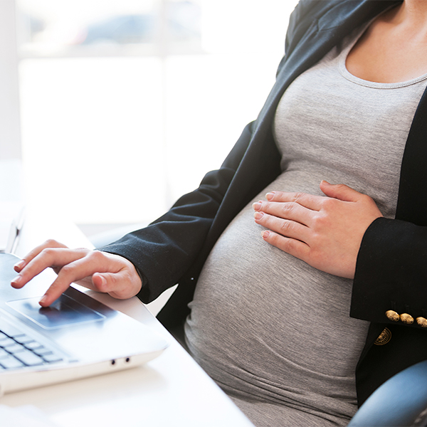 pregnant woman at desk