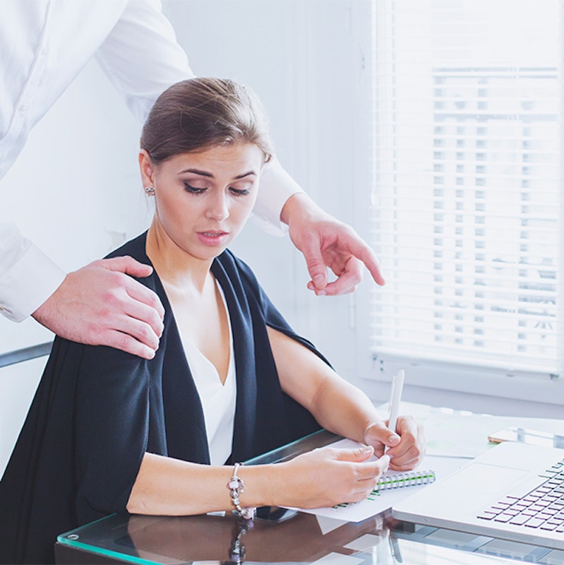 man touching woman's shoulder