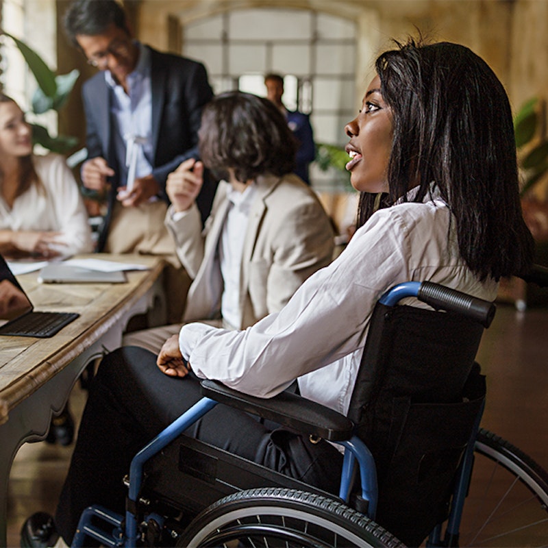 young woman in a wheelchair at a meeting