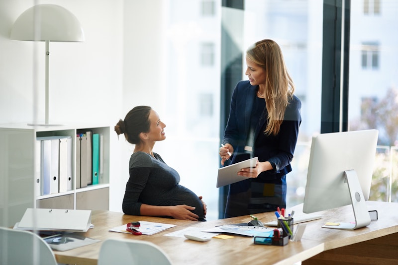 pregnant woman speaking with boss