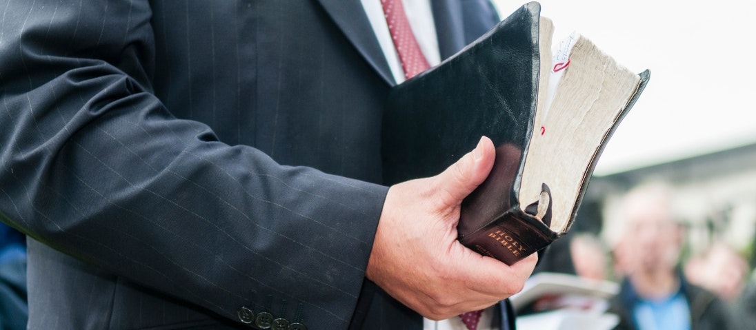 Close-up of a man holding a bible