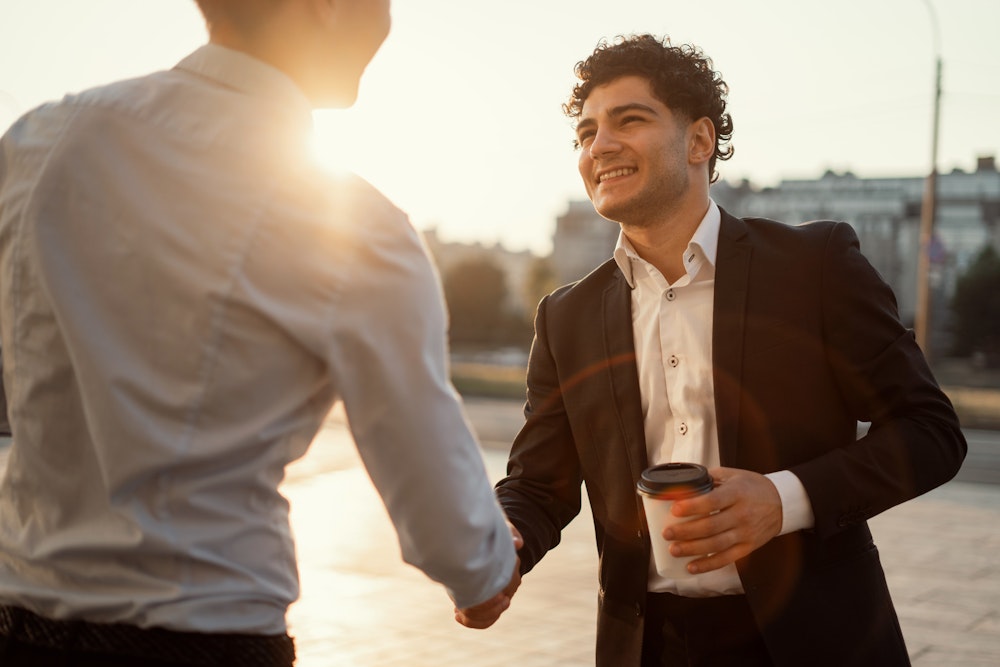 Two men in suits shaking hands