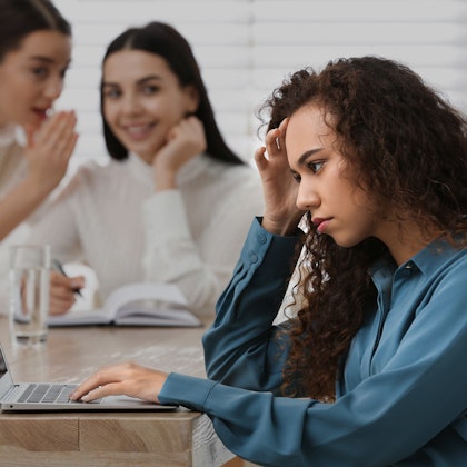 Racial discrimination victim at table