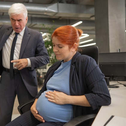 Pregnant woman being yelled at by man in a suit